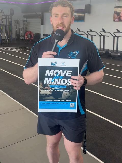 Announcing Move For Minds on the gym floor